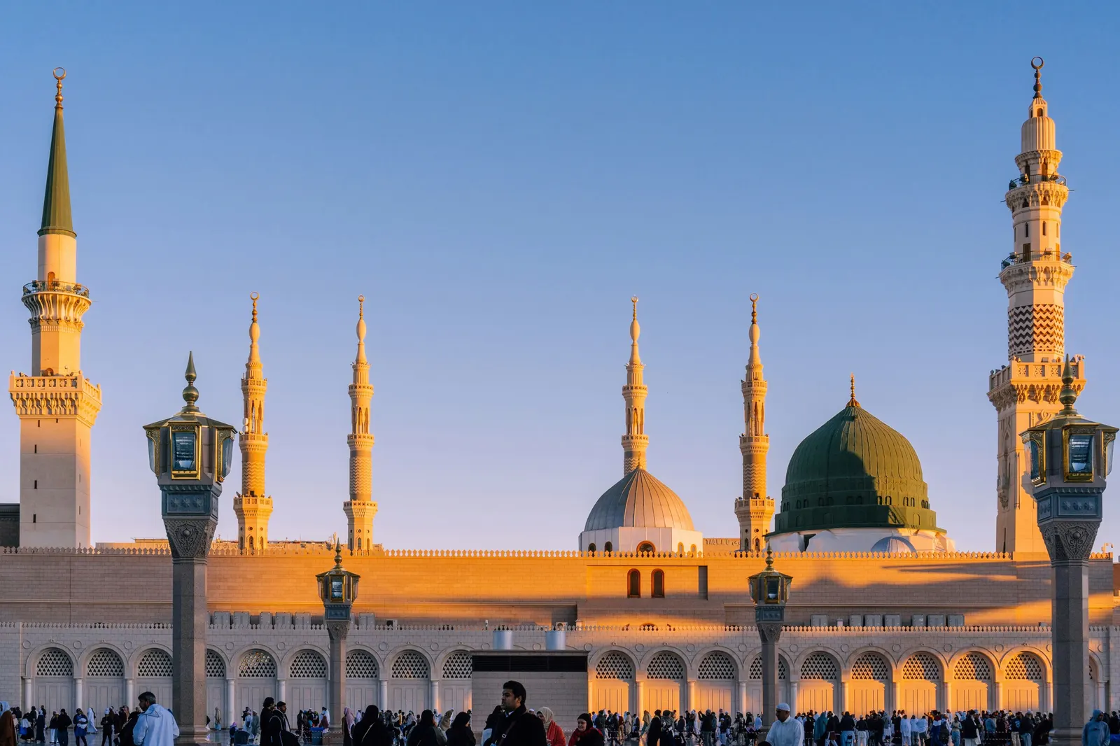 Minarets and domes of Masjid an-Nabawi in soft sunrise light